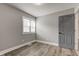 Gray bedroom with a window and light wood-look flooring at 301 Villa Ave, Indianapolis, IN 46201