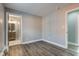 A gray bedroom featuring wood-look flooring and an ensuite bathroom with a glass-enclosed shower at 301 Villa Ave, Indianapolis, IN 46201