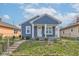 Charming blue home with white trim and covered porch exudes curb appeal and a welcoming entrance at 301 Villa Ave, Indianapolis, IN 46201