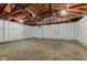 Spacious garage featuring an automatic door and exposed wooden beams at 301 Villa Ave, Indianapolis, IN 46201