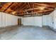 Spacious garage featuring an automatic door and exposed beams at 301 Villa Ave, Indianapolis, IN 46201