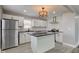 Updated kitchen with white cabinets, a black countertop island, and stainless steel appliances at 301 Villa Ave, Indianapolis, IN 46201