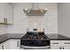 Modern kitchen with stainless steel range hood, black countertops, and white subway tile backsplash at 301 Villa Ave, Indianapolis, IN 46201