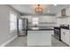 Modern kitchen features white cabinets, an island with black countertops, and stainless steel appliances at 301 Villa Ave, Indianapolis, IN 46201