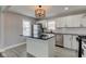 Updated kitchen with white cabinets, black countertops, stainless steel appliances, and a stylish island at 301 Villa Ave, Indianapolis, IN 46201