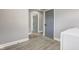 This hallway features a laundry room access, gray walls, wood floors and white trim at 301 Villa Ave, Indianapolis, IN 46201