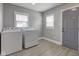 Laundry room with a washer, dryer, and two windows that provide natural light at 301 Villa Ave, Indianapolis, IN 46201