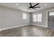 Bright living room features new gray flooring, a modern ceiling fan, and plenty of natural light at 301 Villa Ave, Indianapolis, IN 46201