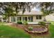 Landscaped backyard with a patio, manicured lawn, and lush greenery at 3034 Tiffany Ct, Carmel, IN 46033