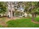 Well-maintained backyard with lush lawn, mature trees, and a patio area at 3034 Tiffany Ct, Carmel, IN 46033