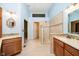Bright bathroom featuring a walk-in shower, dual vanities, and decorative mirrors at 3034 Tiffany Ct, Carmel, IN 46033