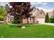 Charming brick home featuring a well-manicured lawn, mature landscaping, and an attached two-car garage at 3034 Tiffany Ct, Carmel, IN 46033