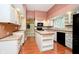 Charming kitchen with white cabinetry, an island with seating, and modern appliances at 3034 Tiffany Ct, Carmel, IN 46033