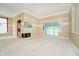 Bright living room with carpet flooring, fireplace, large windows and open access to the sunroom at 3034 Tiffany Ct, Carmel, IN 46033