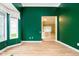 Spacious living room with light green walls, plenty of natural light, and views of an open floor plan at 3034 Tiffany Ct, Carmel, IN 46033