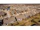 An aerial view displays residences near a pond and community features at 3509 Heathcliff Ct, Westfield, IN 46074