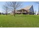 View of the back of the house, a paver patio with a pergola, and a large grassy backyard at 3509 Heathcliff Ct, Westfield, IN 46074
