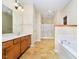 Well-lit bathroom with double sinks, separate shower, and a soaking tub at 3509 Heathcliff Ct, Westfield, IN 46074