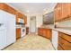 Open kitchen with white appliances, lots of wood cabinets, and view of the sink at 3509 Heathcliff Ct, Westfield, IN 46074