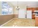 Kitchen with white refrigerator, oak cabinets, and breakfast nook dining area with natural light at 3509 Heathcliff Ct, Westfield, IN 46074