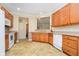 Well-lit kitchen with white appliances, wooden cabinets, and tile floors at 3509 Heathcliff Ct, Westfield, IN 46074
