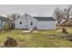 View of the back exterior of a grey home featuring a spacious yard and neutral trim around the windows at 3918 Columbus Ave, Anderson, IN 46013