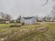 Backyard view of home with expansive lawn and neutral exterior color providing ample space at 3918 Columbus Ave, Anderson, IN 46013