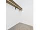 Closet with gray carpet and an installed wooden hanging rod at 3918 Columbus Ave, Anderson, IN 46013
