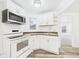 Well-lit kitchen with white cabinets, modern appliances, and sleek countertops at 3918 Columbus Ave, Anderson, IN 46013