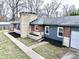 An aerial view of this single-story home with manicured lawn, stone chimney, and attached garage at 405 W 73Rd St, Indianapolis, IN 46260