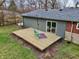 Aerial view of the backyard featuring a wood deck, a lawn, and mature trees at 405 W 73Rd St, Indianapolis, IN 46260