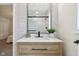 Bathroom featuring new sink with wood cabinet and a view into a stylish glass shower at 405 W 73Rd St, Indianapolis, IN 46260