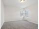 This bedroom features neutral carpet, white walls and trim, and two windows at 405 W 73Rd St, Indianapolis, IN 46260