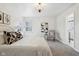 This bedroom features neutral carpet, white walls, two windows, a chandelier, and stylish décor at 405 W 73Rd St, Indianapolis, IN 46260