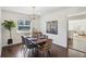 Bright dining room with hardwood floors and a view of the backyard through a large window at 405 W 73Rd St, Indianapolis, IN 46260