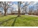 A charming single-story home featuring brick and stone exterior, manicured lawn, and attached garage at 405 W 73Rd St, Indianapolis, IN 46260