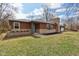 Charming single-story home featuring brick and stone exterior, manicured lawn, and inviting front entrance at 405 W 73Rd St, Indianapolis, IN 46260