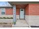 Inviting front entrance of this single-story home with brick facade and meticulously kept landscape at 405 W 73Rd St, Indianapolis, IN 46260