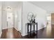 Inviting hallway with wood floors, decorative mirror, and access to various rooms in the home at 405 W 73Rd St, Indianapolis, IN 46260