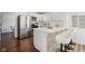 Modern kitchen with stainless steel appliances, white cabinetry, and breakfast bar with stone accents at 405 W 73Rd St, Indianapolis, IN 46260