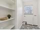 Bright laundry room features stylish patterned tile floors and built-in shelving for easy organization at 405 W 73Rd St, Indianapolis, IN 46260