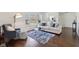 Open living room with hardwood floors, bright windows, and stylish seating arrangement at 405 W 73Rd St, Indianapolis, IN 46260