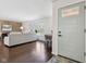 Inviting living room featuring gleaming hardwood floors, light gray paint, and a front door at 405 W 73Rd St, Indianapolis, IN 46260