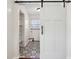Mud room with decorative tile floor behind a sliding barn door at 405 W 73Rd St, Indianapolis, IN 46260