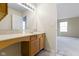 Bright bathroom featuring a vanity with ample counter space and view into the main bedroom at 4062 S Meadow Wood Ct, New Palestine, IN 46163