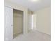 Carpeted bedroom with double door closet and easy access to other living spaces at 4062 S Meadow Wood Ct, New Palestine, IN 46163