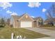 Charming brick and vinyl home with an attached two-car garage and manicured lawn at 4062 S Meadow Wood Ct, New Palestine, IN 46163
