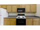 Close-up of the kitchen with a black oven, microwave and wooden cabinets at 4062 S Meadow Wood Ct, New Palestine, IN 46163