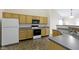Functional kitchen featuring wood cabinets, neutral countertops, and essential appliances including a stove and refrigerator at 4062 S Meadow Wood Ct, New Palestine, IN 46163