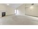 Open living area with carpet, fireplace and sliding door access, offering comfort and functionality at 4062 S Meadow Wood Ct, New Palestine, IN 46163